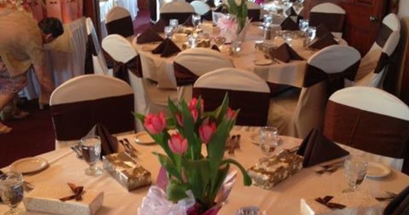 A set table in a banquet room, adorned with vibrant flowers for a charming setting