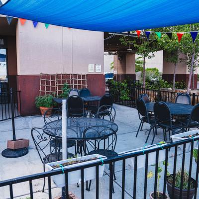 Tables and chairs outside on the patio.