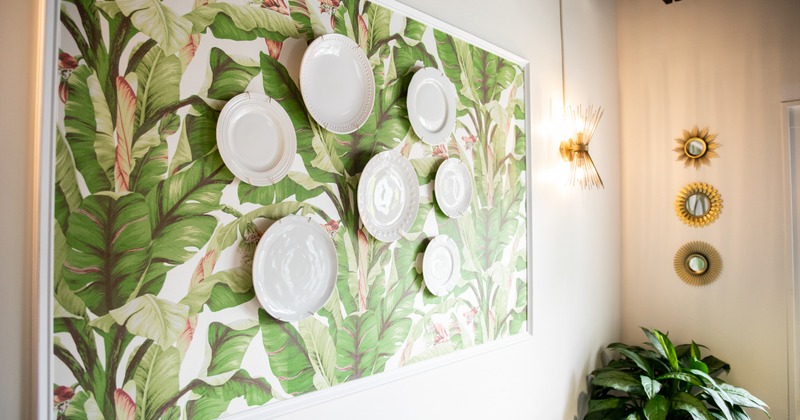Interior, greenery wallpaper decoration with attached white plates