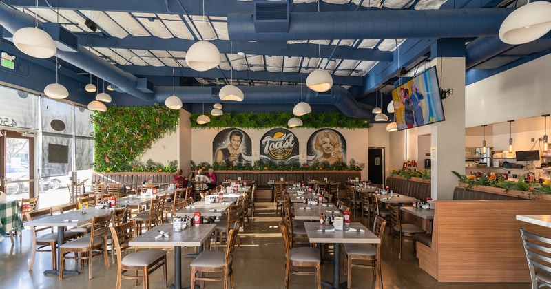 Interior, wide view of dining area, tables and chairs