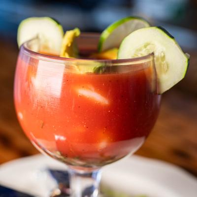 Shrimp cocktail, garnished with lime and cucumber slices.