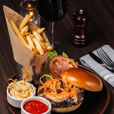 Burger topped with bacon and fried onions, served with coleslaw, fries and a dip.