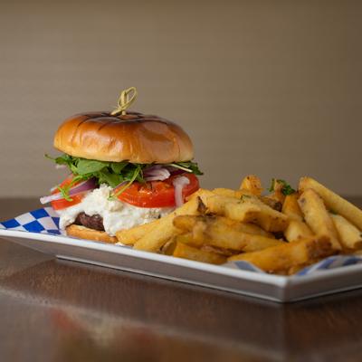 Lamb burger, with feta, arugula, tomato, red onion, tzatziki, and fries.