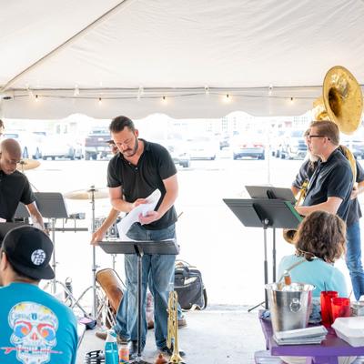 Brass band performing in front of the guests in patio.