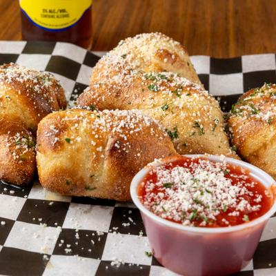 Garlic knots served with marinara sauce.