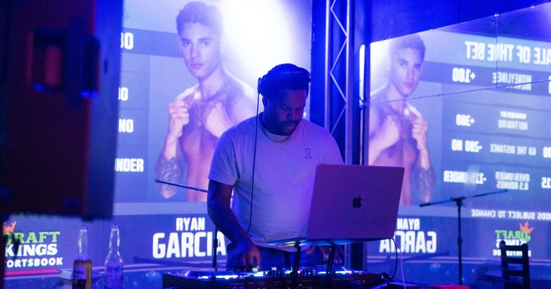 DJ performing, close up, video screens behind