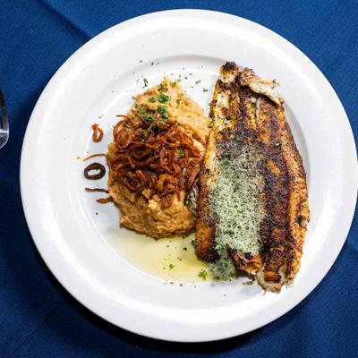 Australian sea bass served with a mash topped with crispy fried onions.
