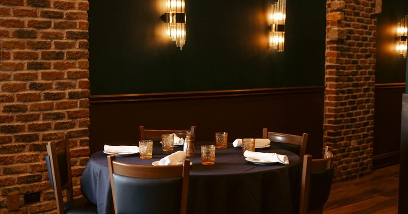 Interior, round table and five chairs, set for dining