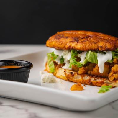 Guajillo dipped & seared bread stuffed with chorizo-potato mix, lettuce, crema, and cheese.