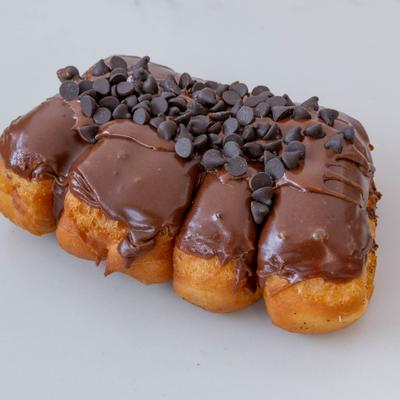 Chocolate bear claw, glazed with chocolate and topped with chocolate chips.