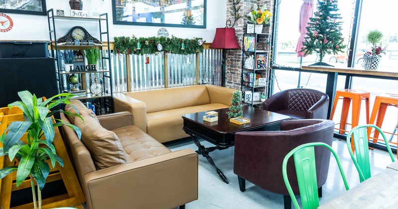 Cozy seating area with beige sofa, maroon armchairs, and a dark wooden coffee table
