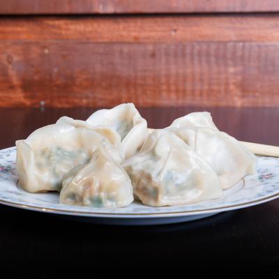 Pork and cabbage dumplings, side view.