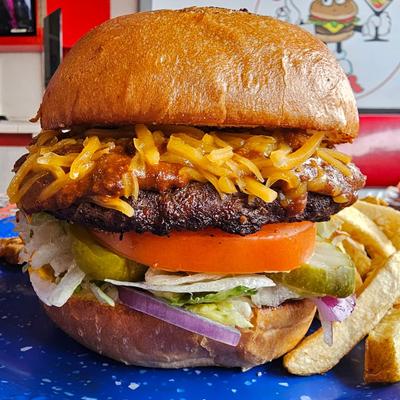 Chili & Cheddar Cheeseburger with fries on the side.