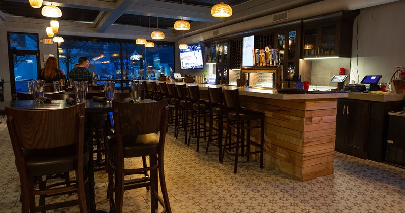 Interior, bar, and bar tables and stools near the bar