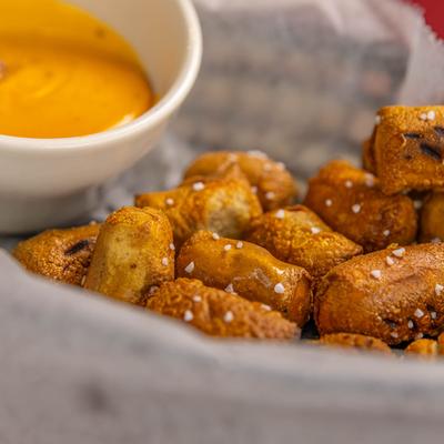Pretzel bites with a small bowl of beer cheese for dipping.
