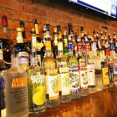 Assorted liquor bottles neatly arranged on a shelf.