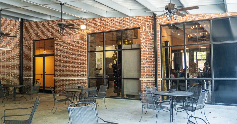 Outdoor patio area with metal tables and chairs