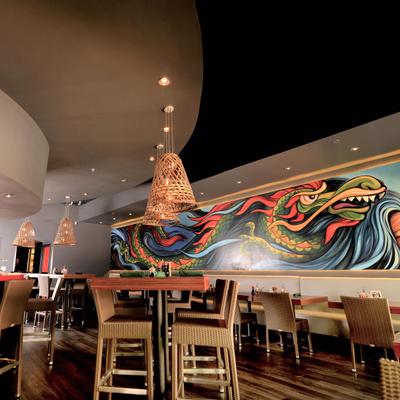 Interior, dining area with a colorful wall mural depicting a dragon.