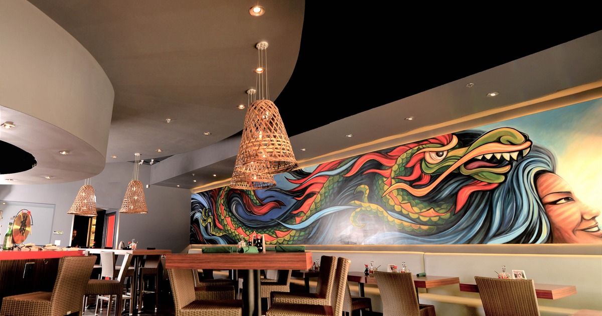 Dining area, colorful wall mural depicting a dragon