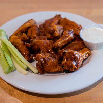 Buffalo wings, with celery, and blue cheese dressing.