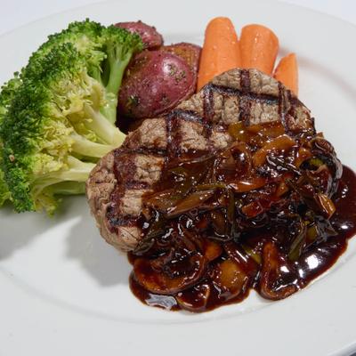 Filet mignon topped in a port wine sauce with mushrooms and leeks, served with veggies.