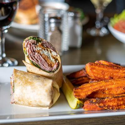 Gorgonzola Roast Beef Wrap with a side of fried sweet potato.
