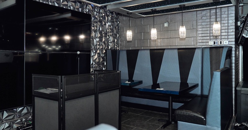 Modern interior with a blue and black booth, pendant lights