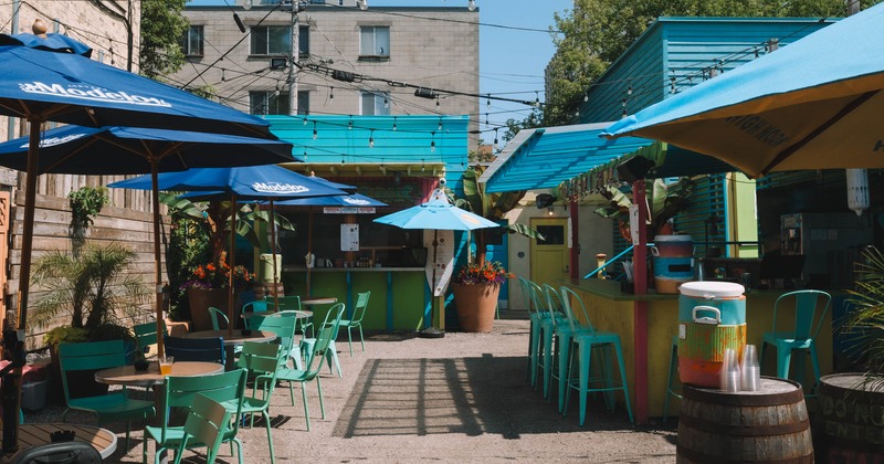 Exterior, tables and chairs ready for guests, bar on the right