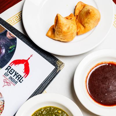 Vegetable samosas served with chutneys.
