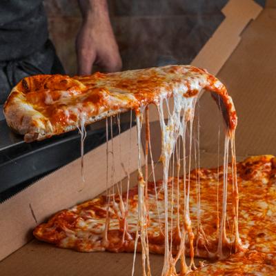Slice of pizza being pulled from the whole pizza.