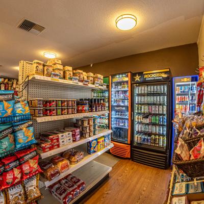 Inteerior with shelves with various snacks and refrigerated sections.
