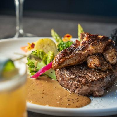 Beef tenderloin, foie gras, smoked mashed potatoes, veggies, and beef jus.
