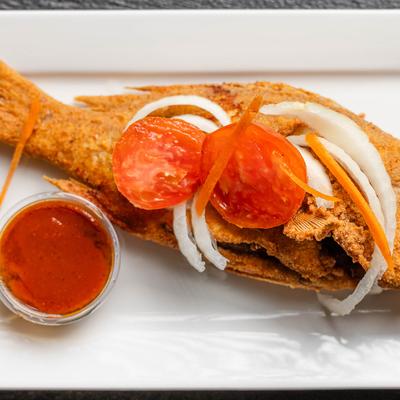 Fried Yellow Snaper served with a sauce on the side.