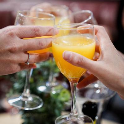 Hands clinking drinks in a toast