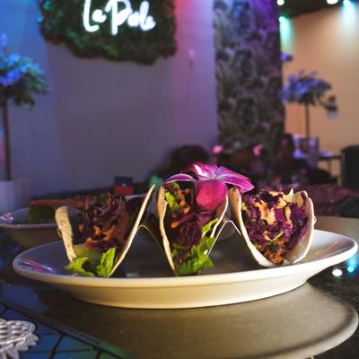 Tacos, with sriracha, red cabbage, and spinach.