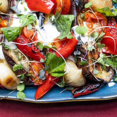 eggplant-yogurt dish with fresh herbs on blue plate