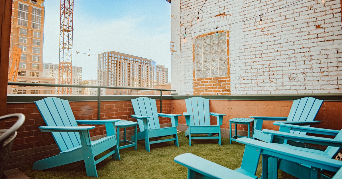 Rooftop patio, lounge seating area with Adirondack blue wooden chairs