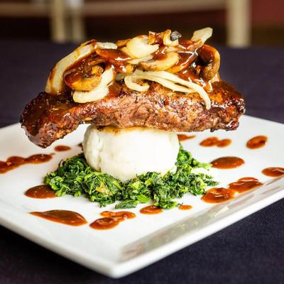 Beef topped with mushroom onion sauce served over mashed potatoes and spinach.