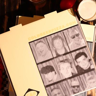 A yellow pizza box featuring the restaurant's website and a collage of portrait photos.