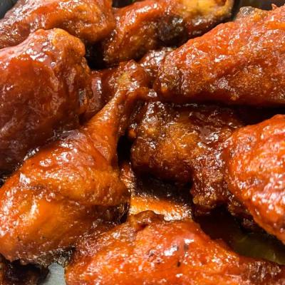 Saucy barbecue chicken wings, close up.