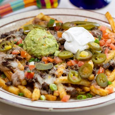 Carne asada fries topped with pickled jalapenos, guacamole, and sour cream.