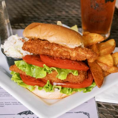 A hearty chicken sub sandwich layered with lettuce, tomato, salad, and creamy dipping sauce..