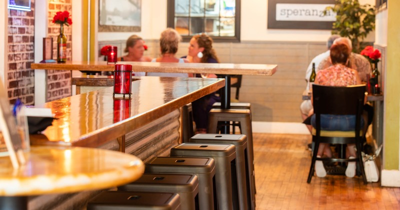 Interior, bar area, guests dining