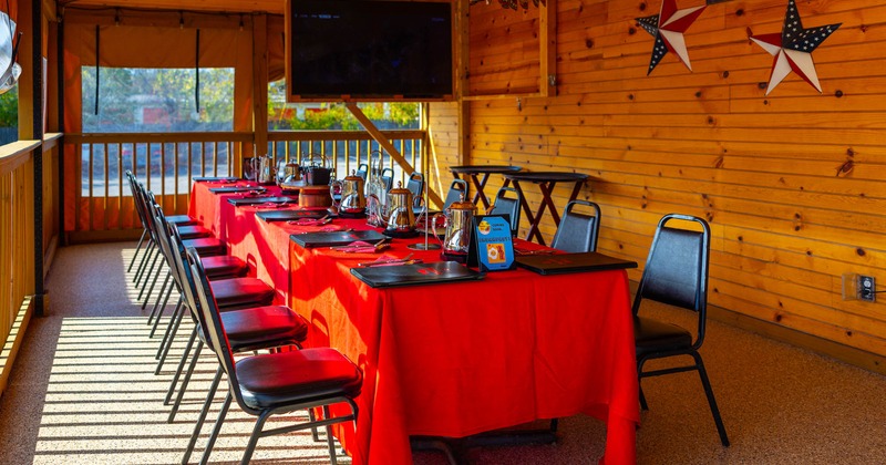 Outside, covered patio, dining tables, chairs, tableware
