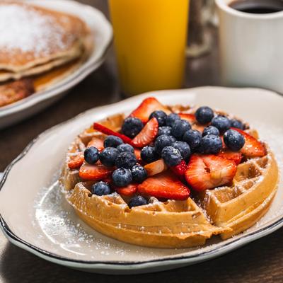 Waffles with fresh berries and syrup.