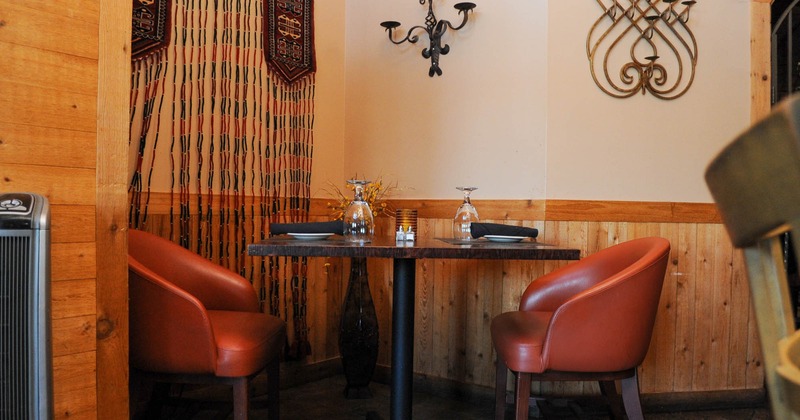 Interior, a set table for two in a corner, decorations on the walls