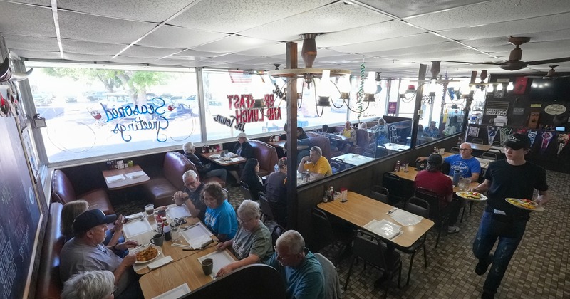 Interior, diner area, tables, benches, people