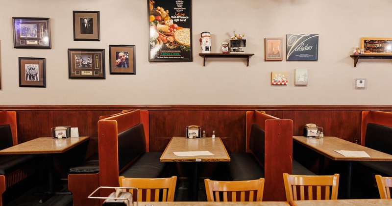Interior, dining area, seating booths with wooden top tables, framed pictures on the wall