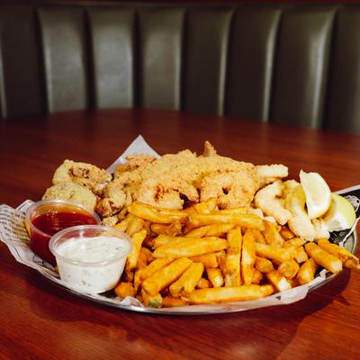 Combo basket with fried fish, fried shrimp, fries, and dipping sauces.