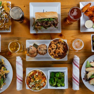 Overhead view of assorted dishes and drinks arranged on a table.
